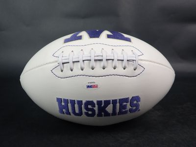 a close up of a football with the word huskies on it