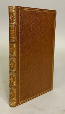 a brown leather book with gold trimming and gold trimming