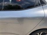 a silver car that is parked in a parking lot