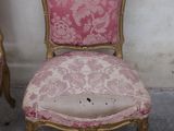 pair of pink and gold chairs in a corner of a room