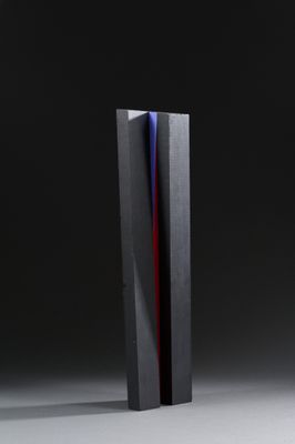 a black and red vase sitting on top of a table