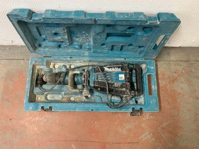 a blue box with a drill in it on the floor