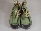 a pair of green shoes with yellow laces on them