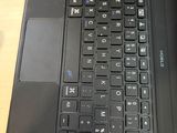 a close up of a laptop keyboard on a wooden table