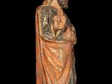 an old wooden statue of a man holding a baby in his arms
