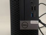 the dell desktop computer is sitting on top of a white surface