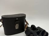 an old pair of binoculars sitting on top of a white surface