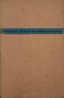 an old book with a blue ribbon on it sitting on a table