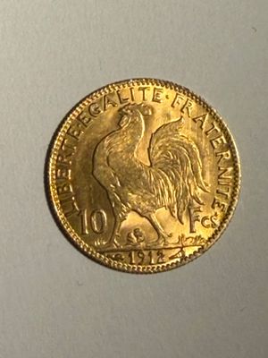 l'image d'une pièce d'or ornée d'un coq