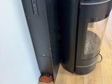 a black coffee maker sitting next to a black trash can