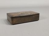 an old wooden box sitting on top of a white surface