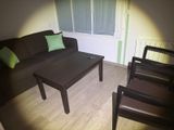 a picture of a living room with a couch, chair, and coffee table