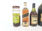 several bottles of alcohol are lined up on a white surface