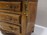 a marble top chest of drawers on a white table