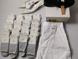 many pairs of socks and a pair of shoes on a table