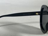 the sunglasses are black and white with gold trims