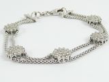 a close up of a silver bracelet on a white background