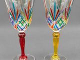 two wine glasses sitting next to each other on a table