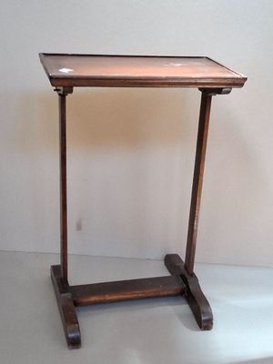 a small wooden table with a glass top on it