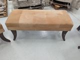two chairs and a ottoman in a room