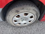 a red car that has a flat tire on it