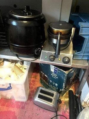 a small kitchen with a stove, toaster, toaster, and other appliances