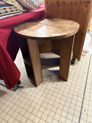 a small table that is on the floor next to a bed