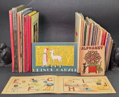 several children ' s books are lined up in a row on a table