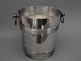 a silver bucket with a handle on a gray background