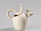 a white vase with a bird on top of it