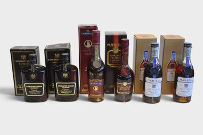 many different types of alcohol bottles and boxes on the table
