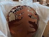 a picture of a large metal sphere in a box
