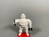 a toy figure of a man holding a baseball bat