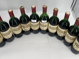 several bottles of wine are lined up on a table