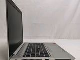 a laptop that is sitting on a white surface