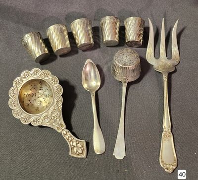 a lot of silver spoons, forks, and a clock
