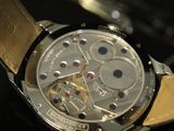 a close up of a watch on a black surface