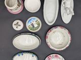 many different types of porcelain dishes and bowls on the table