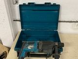 a drill in a blue case on a table