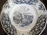 a black and white plate with a picture of a train on it