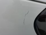 a close up of a white car with a crack in the side of it