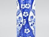 a blue and white vase sitting on a table