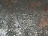 a metal object with a design on it on the ground