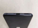 the back of a black cell phone sitting on top of a table
