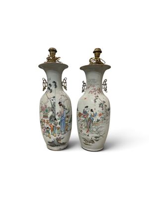 pair of chinese vases with figures on them on a white background