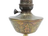 a brass oil lamp that is sitting on a table