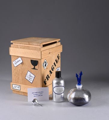 a small wooden box with a bottle of alcohol next to it