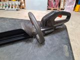 a black and silver stapler sitting on top of a table