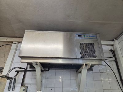 a laptop sitting on top of a table in a kitchen