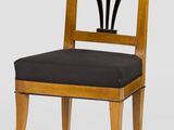 an image of a wooden chair with a black seat on a white background